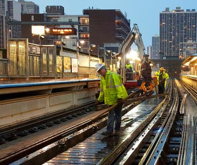Metrorail workers on tracks.